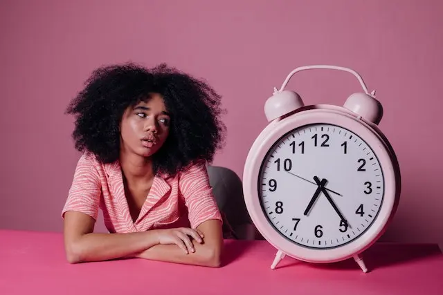 woman looking at clock