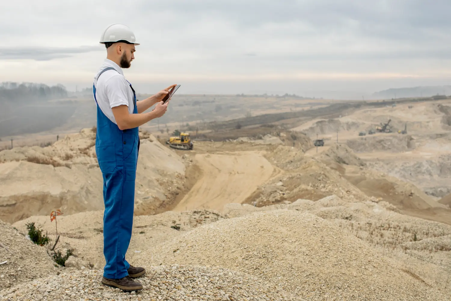 Mine surveyor reviewing site data at an open mining site for Australian tax deductions and compliance