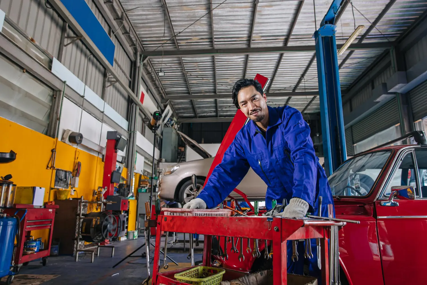 Pit technician working on vehicle maintenance equipment for Australian tax deductions and compliance