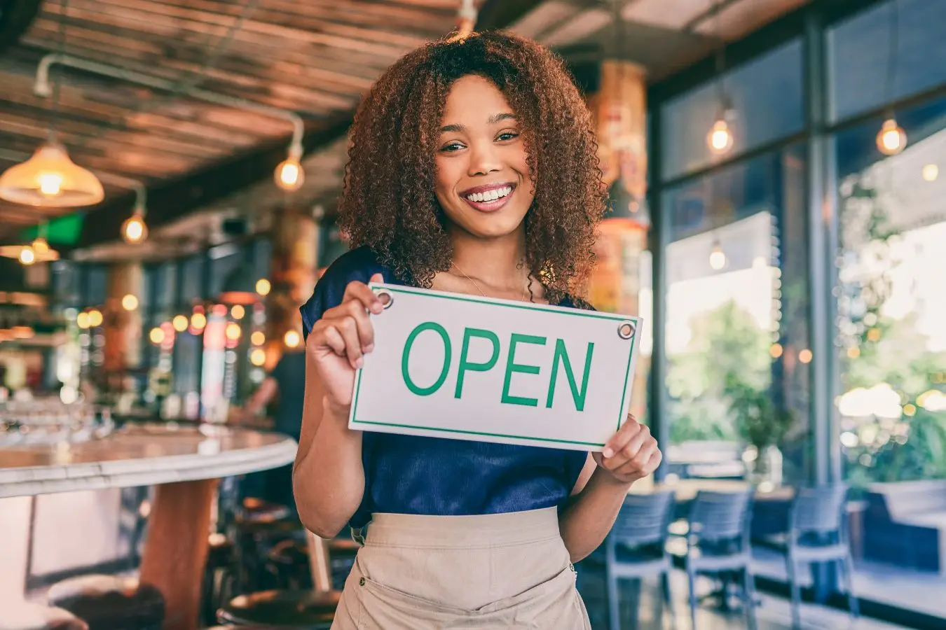 Start up Business woman holding an Open sign